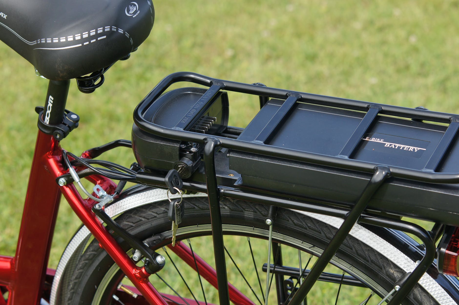 a black battery case on a red e bike in close up shot